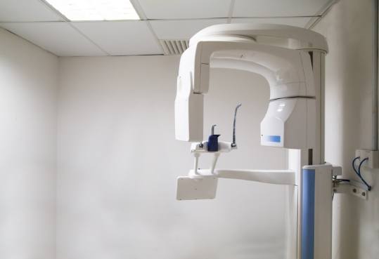 C T cone beam dental scanning technology standing against white wall