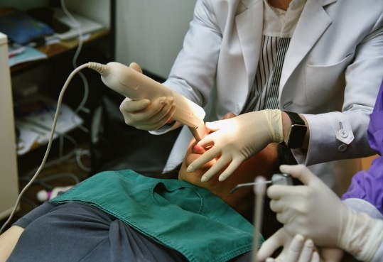 Dentist taking digital impressions of a dental patient