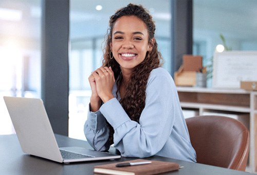 Woman smiling while working in office